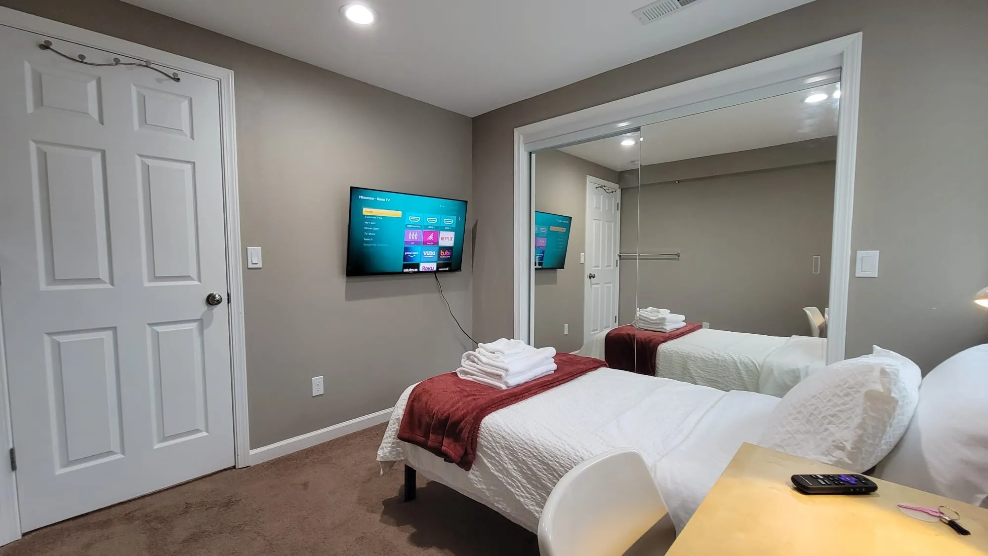 Bedroom interior showing Smart TV, workspace and Full-size bed